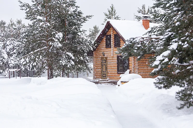 Snow-covered cottage in the woods on the Lake Huron shore near Goderich, Ontario